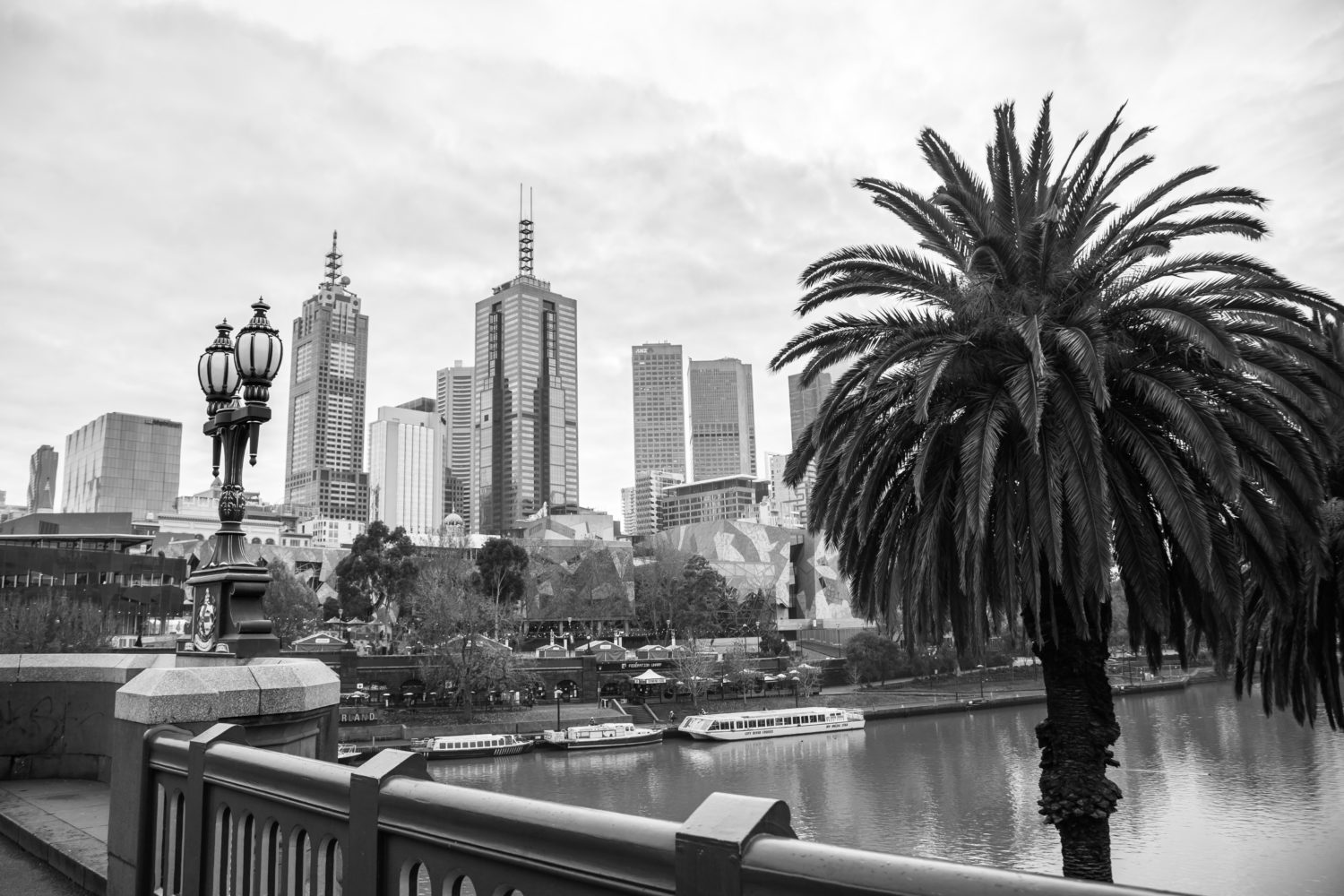 Black and white city view looking over flinders street bridge melbourne